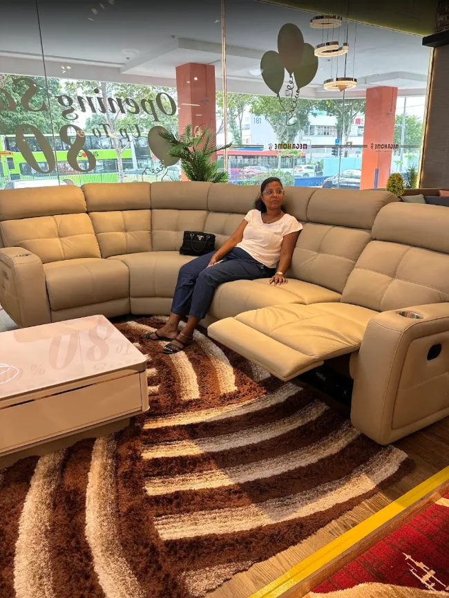 Customer trying out a reclining sofa at the Megahome showroom