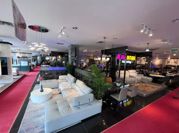 Wide view of the Mega Home Furnishing showroom floor with sofas on display